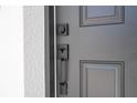 A modern matte black front door features a unique handle and keyless entry at 509 St. Johns Ct, Poinciana, FL 34759