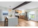 Modern kitchen featuring stainless steel appliances, custom cabinets, a large island, and breakfast bar seating at 5384 Barton Dr, Orlando, FL 32807