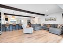 Inviting living room features wood beam, breakfast bar, modern decor, sleek floors and an open-concept design at 5384 Barton Dr, Orlando, FL 32807