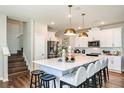 Bright kitchen with white cabinets, stainless steel appliances, an island with seating, and pendant lighting at 564 Southern Edge Way, Sanford, FL 32771