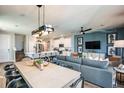 Open-concept living space with modern furnishings and decor, connecting to the kitchen and dining area at 564 Southern Edge Way, Sanford, FL 32771