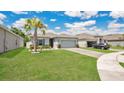 Lovely single-story home with beautiful landscaping, brick driveway and a green lawn under a beautiful sky at 6013 Mount Zion Cir, Deland, FL 32724