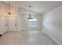 Bright living room featuring tile floors, a front door, and modern light fixtures at 6554 Meritmoor Cir, Orlando, FL 32818