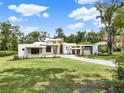 Contemporary home exhibits clean architecture, stone detailing, and lush greenery, exuding modern elegance at 7615 Se 12Th Cir, Ocala, FL 34480