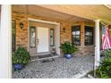 Welcoming front entrance with classic white door, brick facade, and decorative plants at 7618 Majestic Pine Ct, Orlando, FL 32819