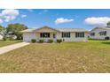 Inviting single-story home with a well-manicured lawn and a cozy front porch at 8443 Sw 109Th Pl, Ocala, FL 34481