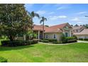 Attractive single story home with a well-maintained lawn and mature trees at 8475 Eagles Loop Cir, Windermere, FL 34786