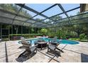 Screened-in pool and spa area with a fire pit and comfortable seating at 8475 Eagles Loop Cir, Windermere, FL 34786