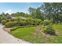 Charming single-story home with lush landscaping, mature trees, and manicured shrubs at 98 Wisteria Dr, Longwood, FL 32779