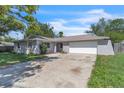 Charming single-story home with a large driveway and an attached two-car garage at 107 Thrush Ln, Casselberry, FL 32707