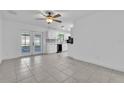 Spacious living room with tile flooring and a view of the updated kitchen at 107 Thrush Ln, Casselberry, FL 32707