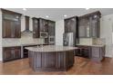 Gourmet kitchen with an island, granite countertops, and stainless steel appliances at 11741 Savona Way, Orlando, FL 32827