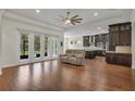 Open floor plan showcasing the living room with hardwood floors flowing into the gourmet kitchen at 11741 Savona Way, Orlando, FL 32827