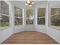 Bright breakfast nook with large windows and hardwood flooring at 12824 Cloverdale Ln, Clermont, FL 34711