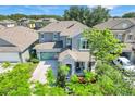 Two-story home in a serene neighborhood with well-maintained lawns and mature trees at 13822 Darchance Rd, Windermere, FL 34786