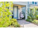 Cozy front porch with a modern chair, plant, and walkway at 14250 Sapelo Beach Dr, Orlando, FL 32827