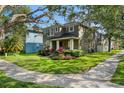 Well-maintained two story house with lush green lawn and colorful landscaping at 14835 Old Thicket Trce, Winter Garden, FL 34787