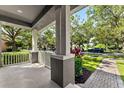 Inviting front porch view with brick pathway and lush green lawn at 14835 Old Thicket Trce, Winter Garden, FL 34787