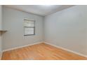 Neutral bedroom with a window providing natural light and classic wood-look floors at 1525 Jaguar Cir, Apopka, FL 32712