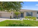 Inviting home with a well-manicured lawn, a lovely front garden, and a welcoming entrance at 15356 White Tail Loop, Mascotte, FL 34753