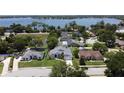 Stunning aerial view of lakeside homes in a quiet neighborhood with mature trees and lush green lawns at 1676 Bear Crossing Cir, Apopka, FL 32703