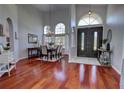Elegant dining room featuring hardwood floors, high ceilings, chandelier, and large windows at 1676 Bear Crossing Cir, Apopka, FL 32703