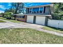 Charming two-story home with a brick accent, a two car garage, and a well-manicured lawn at 1919 E South St, Orlando, FL 32801