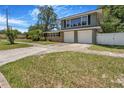 Charming two-story home featuring a brick and gray facade with a two-car garage and well-manicured lawn at 1919 E South St, Orlando, FL 32801