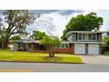 Charming two-story home featuring a brick and gray facade with a two-car garage and well-manicured lawn at 1919 E South St, Orlando, FL 32801