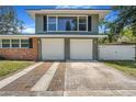 Charming two-story home featuring a brick and gray facade with a two-car garage and well-manicured lawn at 1919 E South St, Orlando, FL 32801