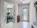 Bright foyer features tile flooring, a decorative front door, and access to an adjacent room at 200 Azure Mist Way, Daytona Beach, FL 32124