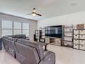 Comfortable living room with neutral paint, tile floors, and a large window for natural light at 200 Azure Mist Way, Daytona Beach, FL 32124