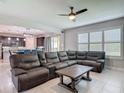 Spacious living room with a large sectional couch, adjacent to the dining and kitchen areas at 200 Azure Mist Way, Daytona Beach, FL 32124