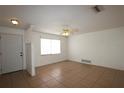 Bright living room showcasing tiled floors, a ceiling fan, and plenty of natural light at 2013 Dearing Ave, Deltona, FL 32725