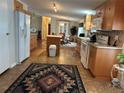 A fully equipped kitchen with white appliances, a tile floor, and wood cabinets at 361 Dreama Dr, Davenport, FL 33897
