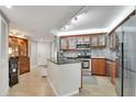 Well-appointed kitchen with stainless steel appliances, granite countertops, and wood cabinets providing ample storage at 400 E Colonial Dr # 1609, Orlando, FL 32803