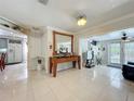 Inviting foyer and open living room with large tile floors, and a view into the kitchen at 4021 Queen Anne Dr, Orlando, FL 32839