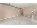 Spacious living area with neutral paint, and tile flooring throughout the open-concept layout at 476 Basking Ridge Ct, Ocoee, FL 34761