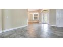 A bright foyer with decorative glass front door, gray tile flooring, and neutral paint at 529 Quail Down Dr, Debary, FL 32713