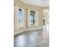 Cozy living room with large windows offering serene lake views and neutral colors at 529 Quail Down Dr, Debary, FL 32713
