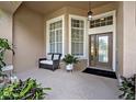 Inviting front porch with seating area and decorative plants, offering a warm welcome at 533 Pickfair Ter, Lake Mary, FL 32746