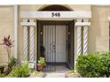 Inviting front door with secure gate, decorative columns, and potted plants, creating a welcoming entrance at 548 S Hyer Ave # 1, Orlando, FL 32801