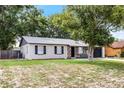 Well-maintained single-story home with a neat lawn and mature trees providing ample shade at 558 Tyler Ave, Deltona, FL 32725