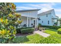Charming single-story home with covered porch and meticulously maintained front yard at 8518 Nemours Pkwy, Orlando, FL 32827