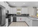 Modern kitchen featuring stainless steel appliances, ample cabinet space, and a stylish tile backsplash at 8822 Interlocking Ct, Davenport, FL 33896