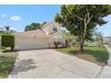 Well maintained two-story home featuring an attached two car garage and mature landscaping at 9145 Fort Jefferson Blvd, Orlando, FL 32822