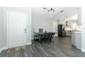 Open-concept dining area featuring new flooring, a built-in dining nook, and seamless access to the modern kitchen at 1077 Dees Dr, Oviedo, FL 32765