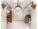 Spacious foyer with tile flooring, a decorative chandelier, and a view into other rooms at 11512 Clair Pl, Clermont, FL 34711