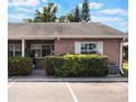 Charming brick condo featuring a well-maintained lawn and assigned parking spaces at 1230 Americana Pl, Orlando, FL 32807