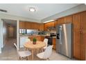 Efficient kitchen with a breakfast nook, appliances, and ample wood cabinetry at 1230 Americana Pl, Orlando, FL 32807